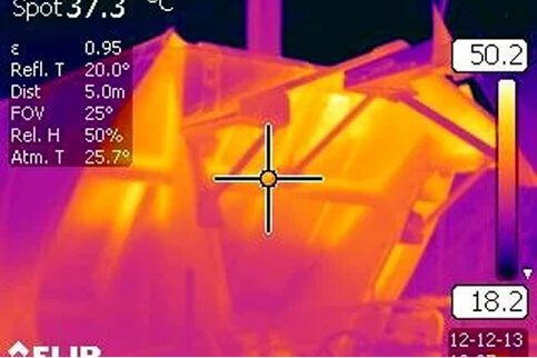Thermal camera image of roof and ceiling structures revealing heat patterns and possible insulation or electrical issues identified through thermographic testing.